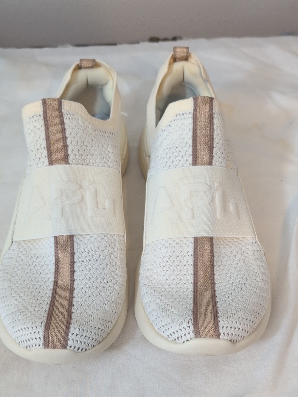 APL Women's Slip-On Sneakers in Cream with Rose Gold Stripe